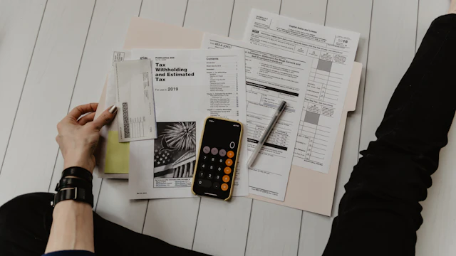 Calculator and financial paperwork used to estimate business expenses