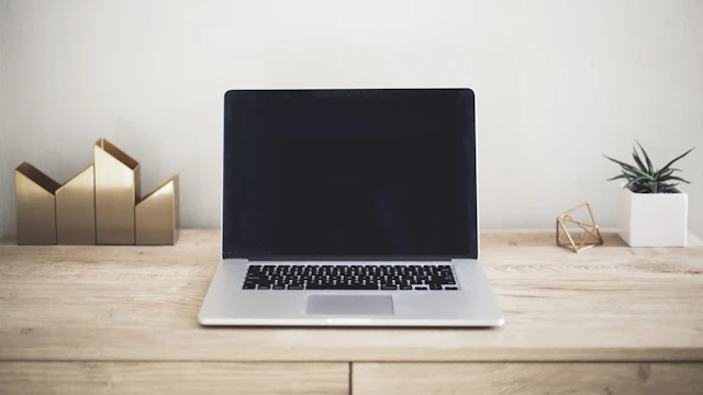 Open laptop on a simple desk used for everyday business tasks