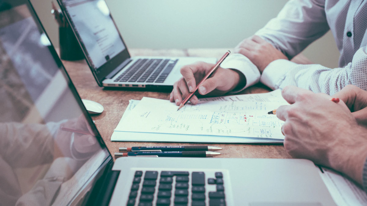 Business planning documents spread across a desk during a discussion